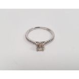 Platinum solitaire diamond brilliant-cut ring, claw-set with multiple diamonds to the shoulders, the