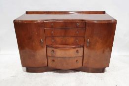 Early 20th century walnut sideboard by Beautility, the serpentine front with assorted drawers and