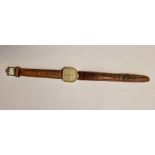 Lady's rolled gold-cased Omega wristwatch, the champagne square dial with hour batons, on a