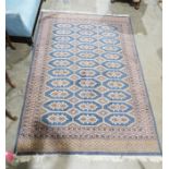 Modern Eastern wool rug with eleven rows of three octagonal guls having geometric motif, lozenge and