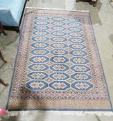 Modern Eastern wool rug with eleven rows of three octagonal guls having geometric motif, lozenge and