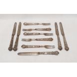 Set of five silver-handled fruit knives and forks with embossed berry on vine decoration to the