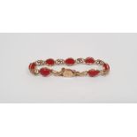 14k yellow gold bracelet set with red cabochon stones