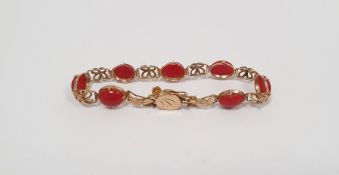 14k yellow gold bracelet set with red cabochon stones