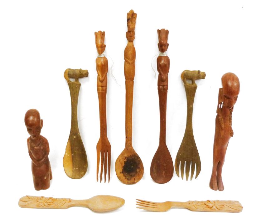 Collection of African carved wooden spoons and figures.