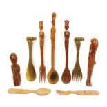 Collection of African carved wooden spoons and figures.