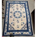 Chinese cream ground superwash rug with central geometric medallion surrounded by floral