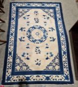 Chinese cream ground superwash rug with central geometric medallion surrounded by floral