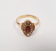Probably 18ct gold, garnet and seedpearl marquise ring, centred by facet-cut stone with seedpearls