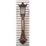 Mercury stick barometer and thermometer in ornately carved mahogany case