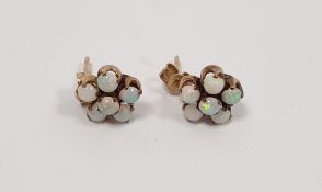Pair of gold cluster opal earrings, not hallmarked Condition Reportone of the centre stones with