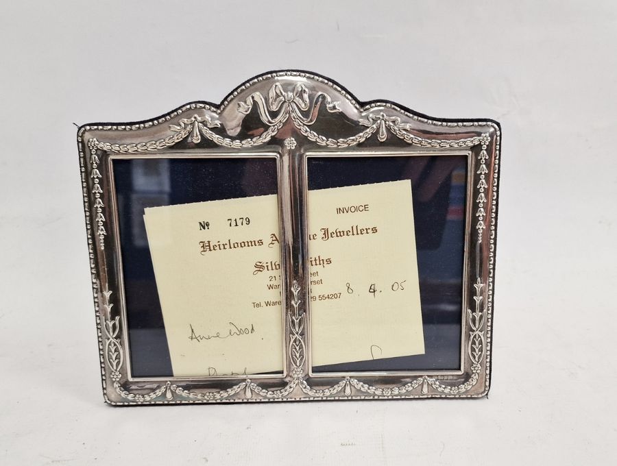 Modern silver double photograph frame with bow and swag decoration, 18cm x 22cm