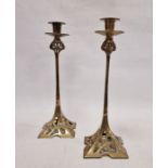 Pair of Art Nouveau brass candlesticks with shaped square pierced bases