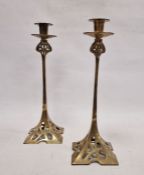 Pair of Art Nouveau brass candlesticks with shaped square pierced bases