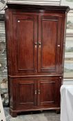 19th century mahogany corner cupboard, the ogee moulded cornice above two pairs of panelled cupboard