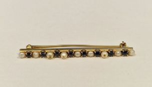 Gold, sapphire and pearl bar brooch set multiple claw set stones and small pearls