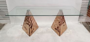 Modern glass-topped table with triangular prismic hammered copper twin-pedestal base, 15mm toughened