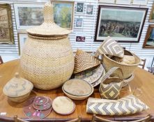 Quantity of African woven wares, to include baskets, trays and hats, some featuring zig-zag, diamond