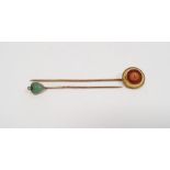 Gold and coral stickpin set single coral within circular surround and fine ropetwist border and a