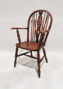 20th century elm-seated wheelback carver chair on turned front legs, stretchered base