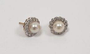 Pair of 18ct white gold stud earrings set with pearls and diamonds, stamped 750 Condition