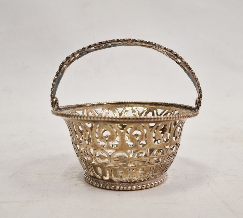 Foreign silver-coloured pierced flared cylindrical basket, the pierced swing handle within beaded