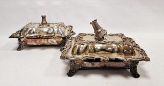 Pair of Victorian silver tureens with silver castle handles, scrolling rococo-style decorated lid