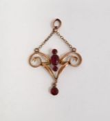 Late Victorian/Edwardian gold-coloured metal and almandine garnet pendant, scroll design set four