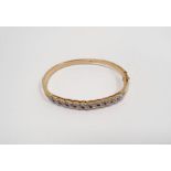 18ct yellow gold bangle set with tiny diamonds in open S-scroll band, 20g gross approx.