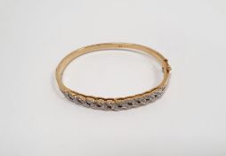 18ct yellow gold bangle set with tiny diamonds in open S-scroll band, 20g gross approx.