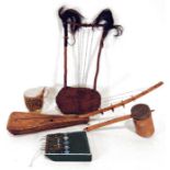 Two African hide stringed instruments, a pan drum, a painted wooden kalimba and a further drum.