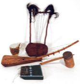 Two African hide stringed instruments, a pan drum, a painted wooden kalimba and a further drum.