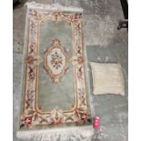 Modern Chinese green ground superwash rug with central floral medallion with floral border 153cm x