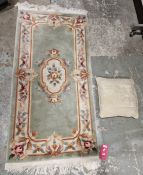 Modern Chinese green ground superwash rug with central floral medallion with floral border 153cm x