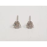 Pair diamond solitaire stud earrings in white metal claw settings, total 1.4ct approx. Condition