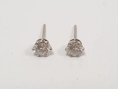 Pair diamond solitaire stud earrings in white metal claw settings, total 1.4ct approx. Condition