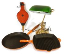 Le Creuset cast iron frying pan, a Le Creuset cast iron griddle pan, a pair of bellows and a desk