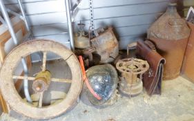 WWI metal helmet, a vintage manual crop spreader, a vintage wheelbarrow wheel, various vintage oil