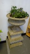 Composite stone urn on plinth base, 87cm high approx.