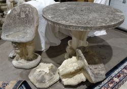 Composite stone circular garden table with incised floral decoration to the centre, on plinth