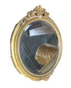 Gilt and gesso framed oval wall mirror, a Best Lloyd urn-shaped table lamp with relief drape