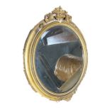 Gilt and gesso framed oval wall mirror, a Best Lloyd urn-shaped table lamp with relief drape