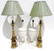 Pair of plaster urn-shaped table lamps with relief cherub decoration and a pair of brass table lamps