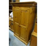 Pine two-door wardrobe raised on bracket feet, 177.5cm x 106.5cm x 58cm