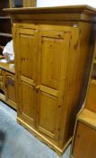 Pine two-door wardrobe raised on bracket feet, 177.5cm x 106.5cm x 58cm