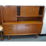 Teak mid-century modern lounge unit with cocktail cabinet to the left, sliding cupboard doors open