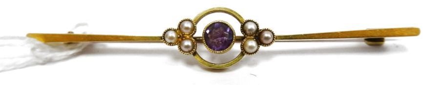Gold-coloured amethyst and seedpearl bar brooch set centre amethyst flanked by trefoils of
