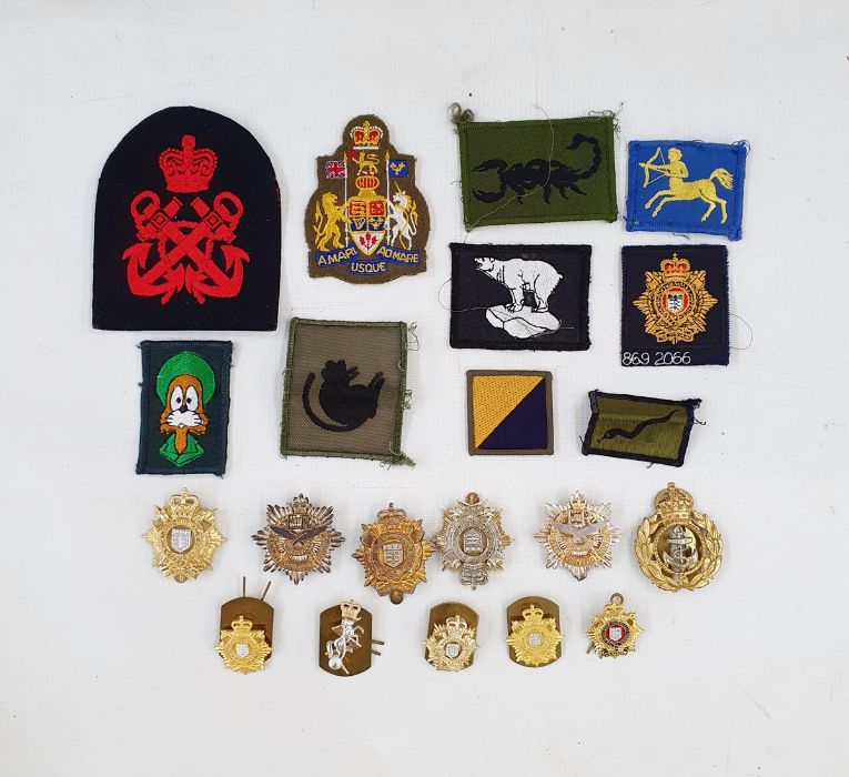Collection of modern military cap badges, rank markings and cloth badges.  Together with five
