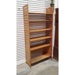 Mid-century modern teak Ladderax-style shelving system with four shelves and unit with sliding glass