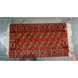 Modern red ground rug with elephant foot guls to central field, in reds, oranges and creams, 116cm x